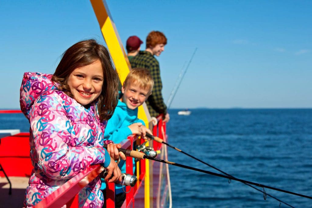 A family enjoys a fishing charter experience on Mille Lacs Lake.