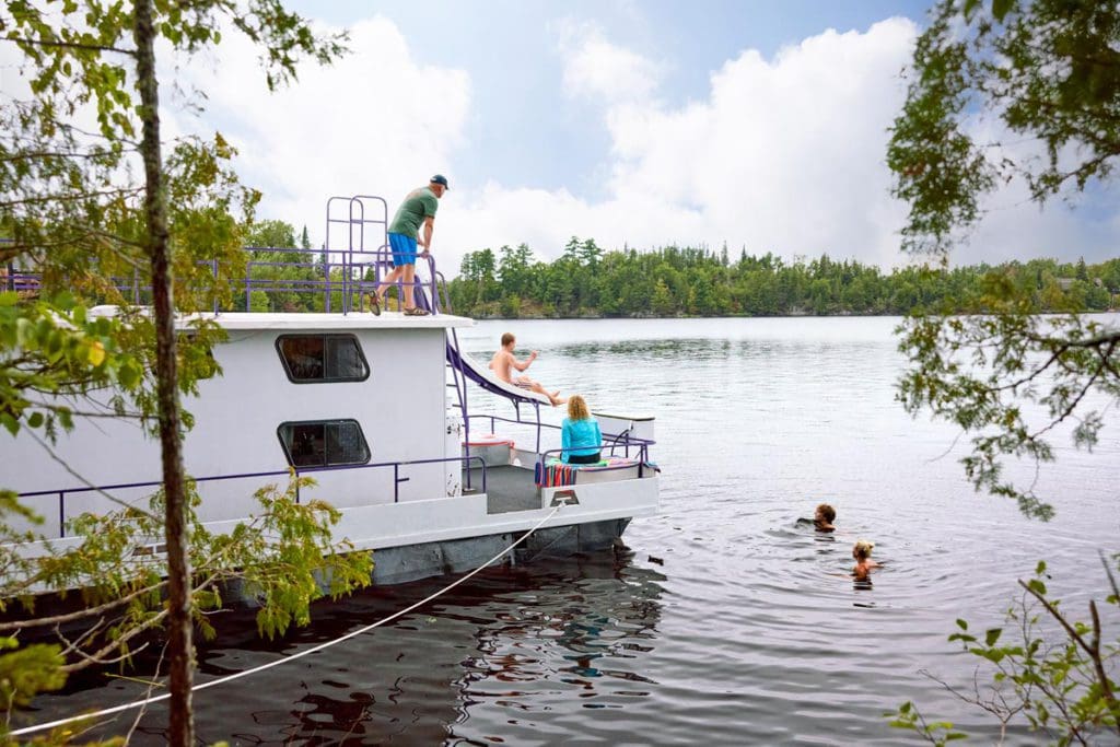 A family enjoys a tour around Rainy Lake on a houseboat.