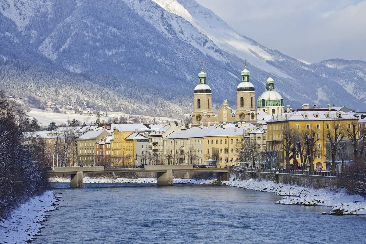A view of St. Jakob Cathedral or the Cathedral of St. James in the snow, one of the best things to do in Innsbruck with kids this winter.