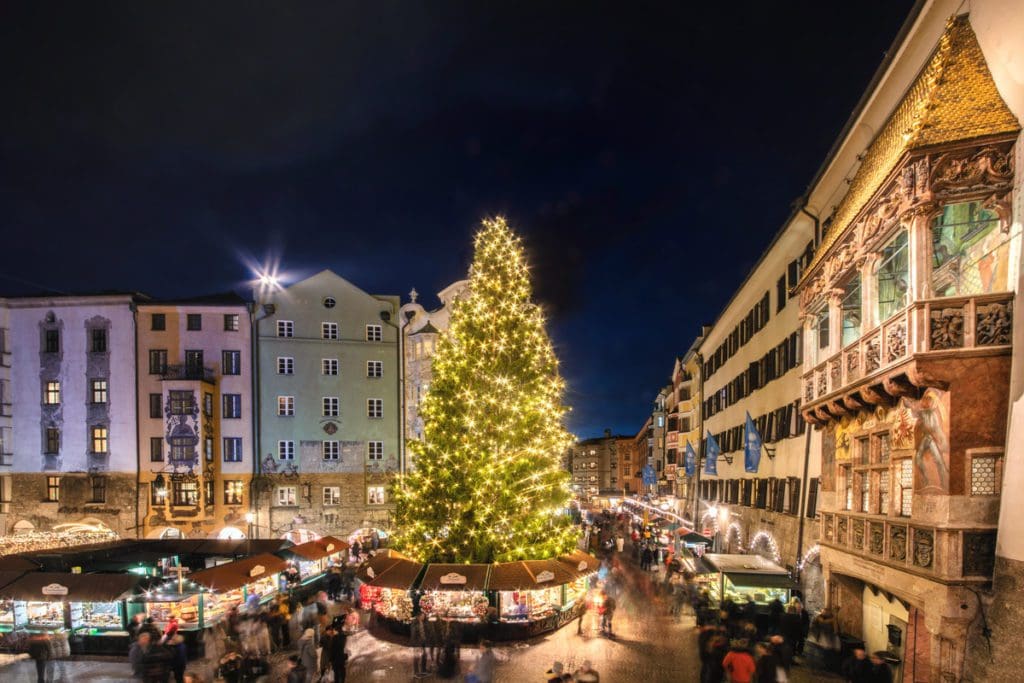 The large Christmas tree lit up at night at the Christmas market old town in Innsbruck.