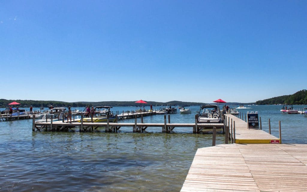 A dock holding several boats on Walloon Lake in Michigan.