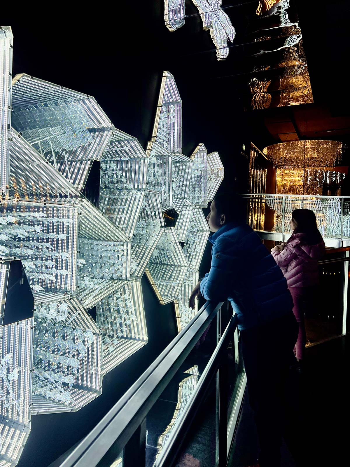Two kids look at a crystal exhibit at Swarovski Kristallwelten.