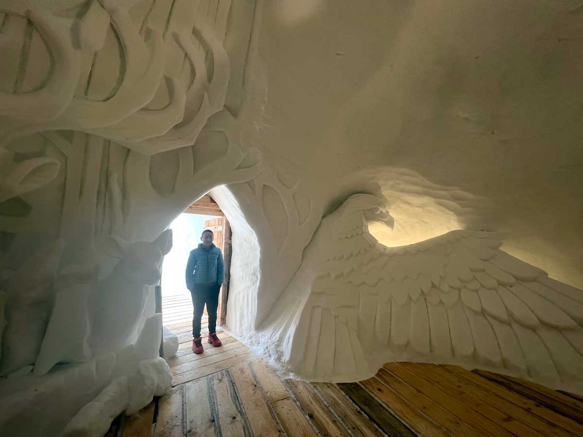 A young boy explores a decorative igloo at the Top of Innsbruck.