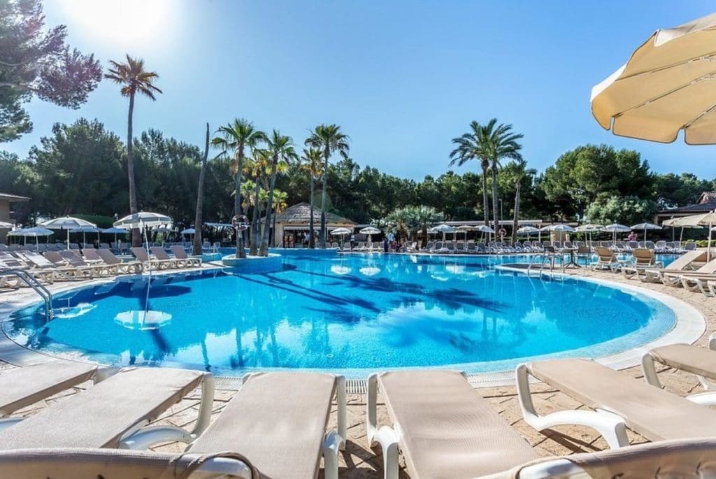 The on-site circle pool, with surrounding pool deck and loungers at Vell Mari Hotel and Resort on a sunny day, one of the best all-inclusive hotels in Mallorca for families.