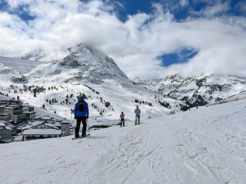 A dad and his two young kids ski across a trail near Innsbruck.