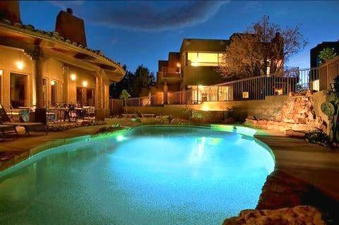 The outdoor pool at Adobe Grand Villas at night, one of the best hotels in Sedona for families.