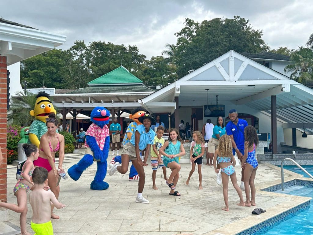 Kids sing and dance with Sesame Street characters and Beaches Negril staff during a dance party.