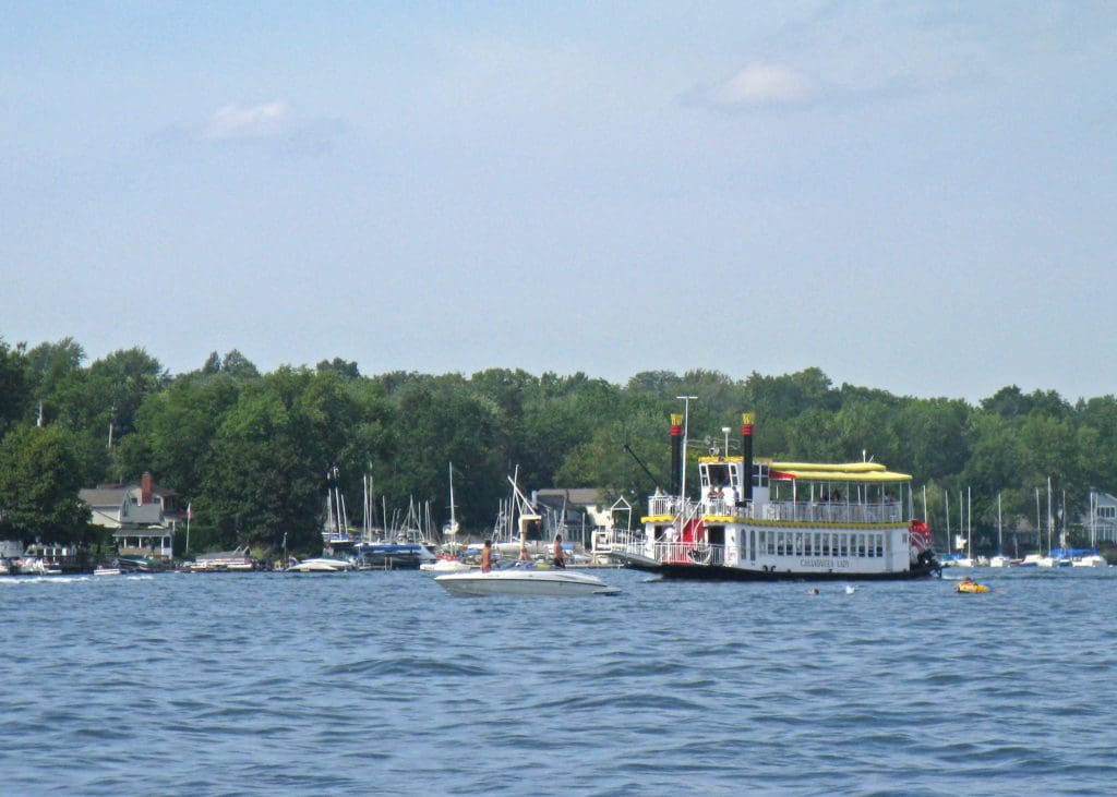A boat moves across the waters of Canandaigua Lake, one of the best lakes in New York State for families.