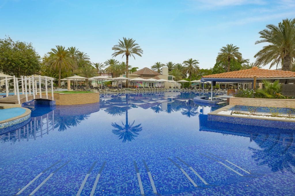 The outdoor pool and surrounding pool deck at Habtoor Grand Resort, Autograph Collection.