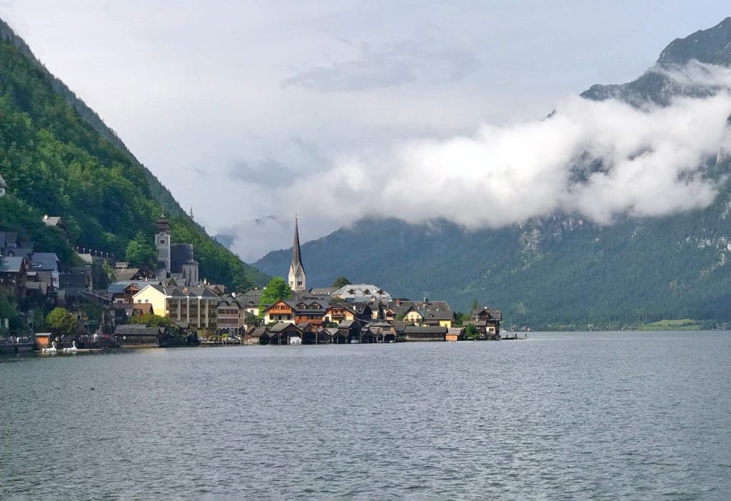 A view of he beautiful city of Hallstatt along the water.