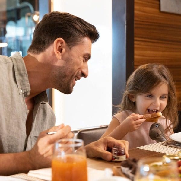 A dad and his young daughter enjoy breakfast at Hilton Dubai Palm Jumeirah.