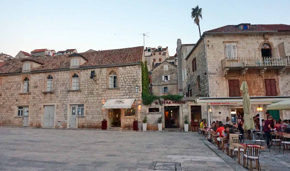 A city square surrounded by historic buildings in Hvar, one of the best places to visit in Croatia with kids this summer.