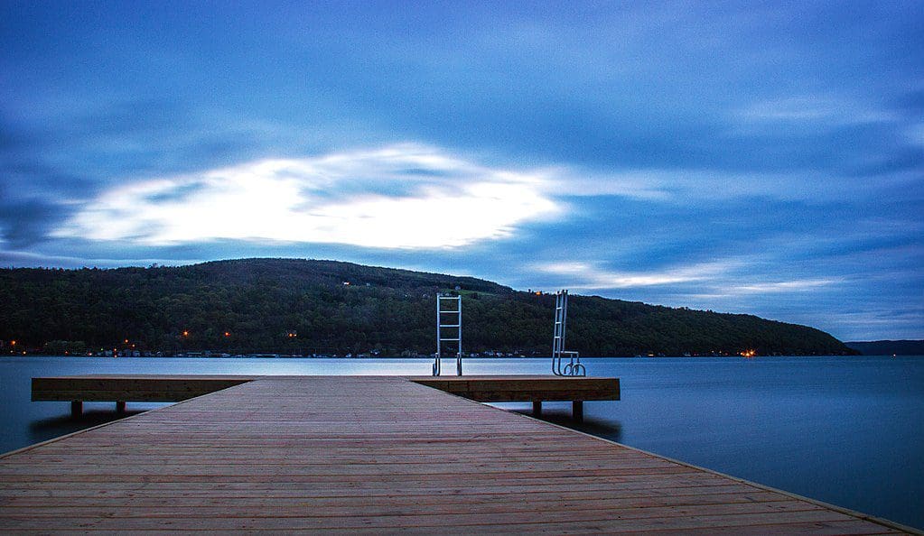 A dock sits above the water on Keuka Lake, one of the best lakes in New York State for families.