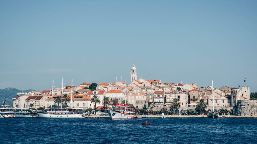 A view of the Old Town in Korčula, from across the water, one of the best places to visit in Croatia with kids this summer.