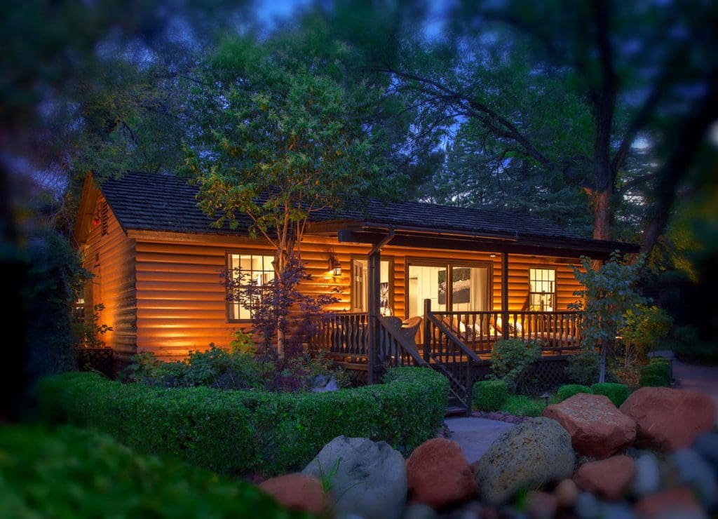 The exterior of a cabin at L’Auberge de Sedona at night.