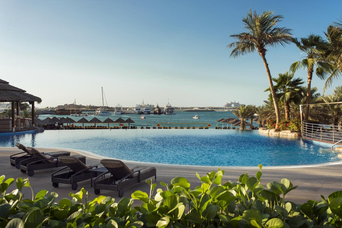 The pool with a view of the ocean at Le Méridien Mina Seyahi Beach Resort & Waterpark, one of the best beachfront hotels in Dubai for families