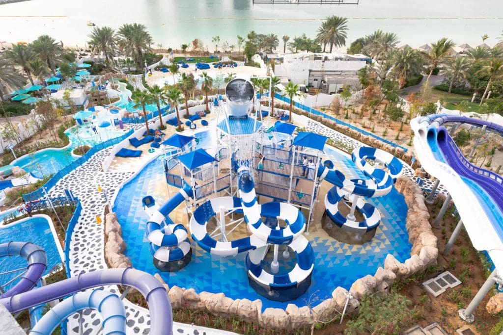 An aerial view of the fun waterpark at Le Méridien Mina Seyahi Beach Resort & Waterpark, one of the best beachfront hotels in Dubai for families.