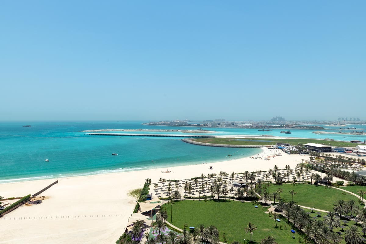 An aerial view of the sandy beach at Le Royal Méridien Beach Resort & Spa, one of the best beachfront hotels in Dubai for families.