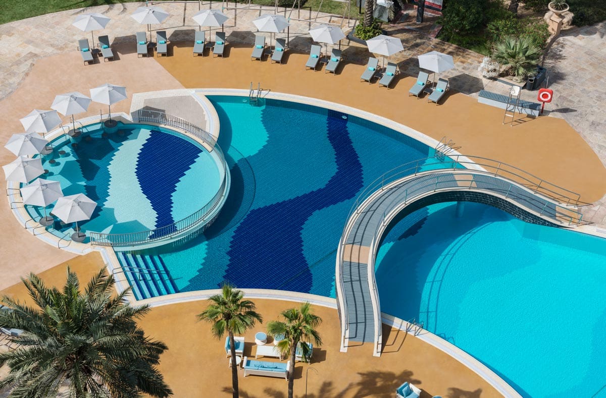 An aerial view of the pool and pool deck at Le Royal Méridien Beach Resort & Spa.