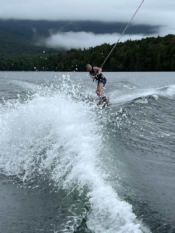 A teen waterskis behind a boat on Lake Placid.