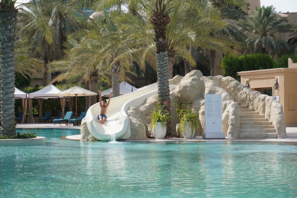 A young boy shoots down a waterslide at One&Only Royal Mirage.