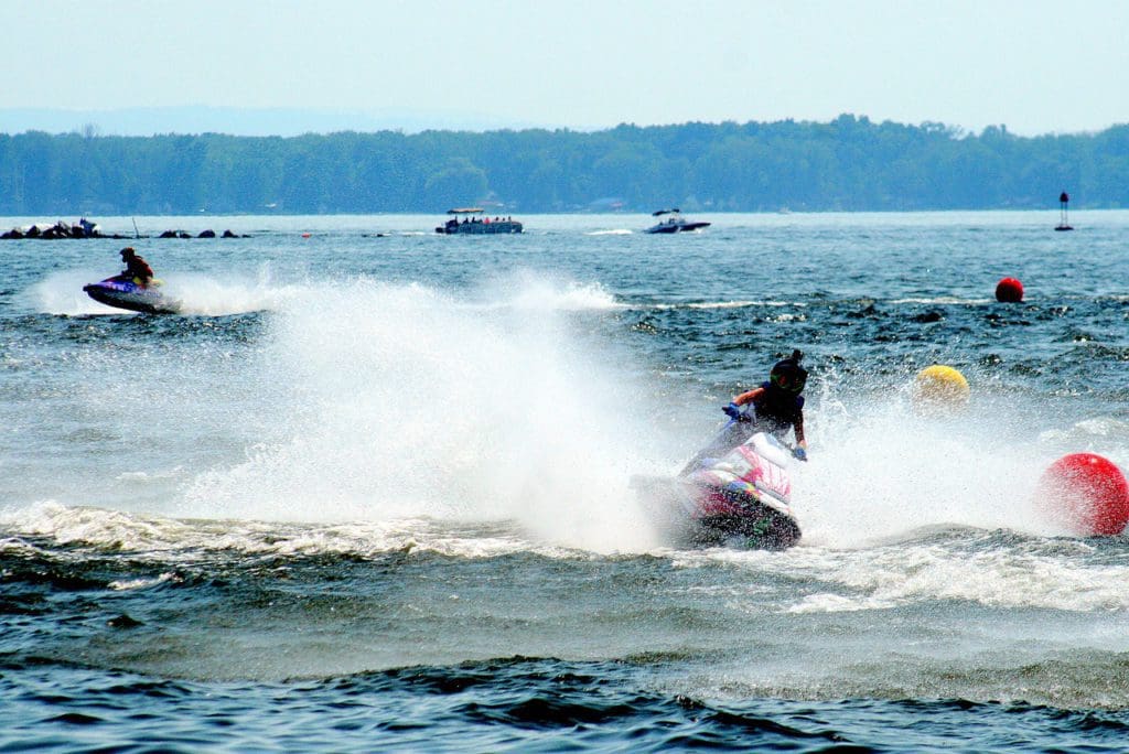 People jet skiing on Oneida Lake, one of the best lakes in New York State for families.