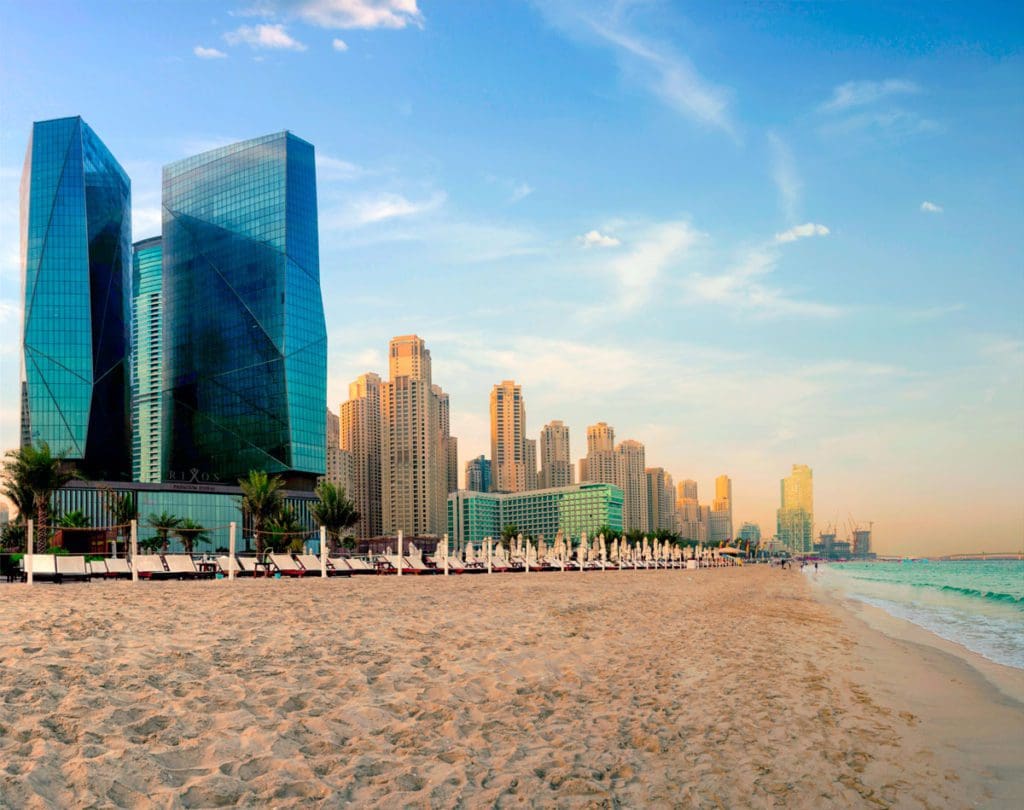 The exterior of Rixos Premium Dubai JBR along the beach on a beautiful day.