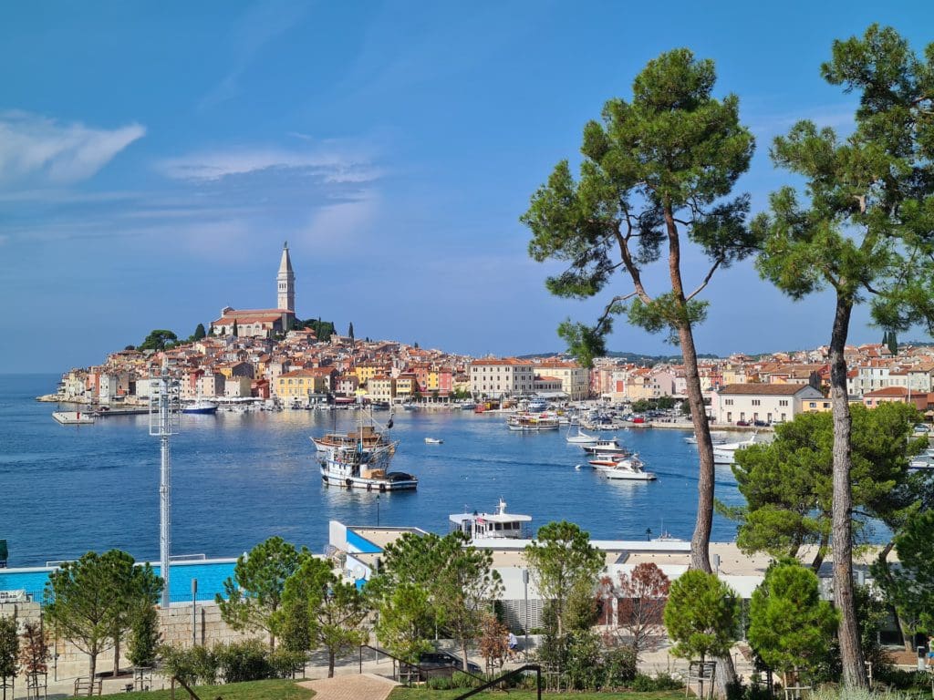 An aerial view of the port of Rovinj, with the historic center in the distance.