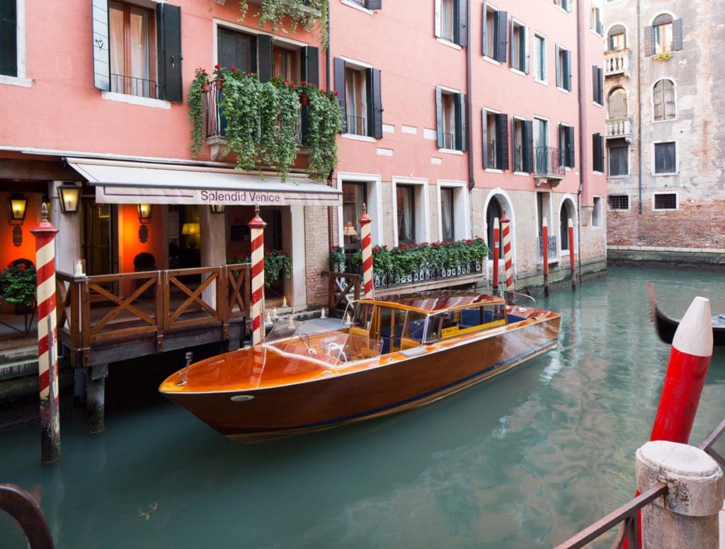 A boat parked in the canal outside the entrance to Splendid Venice - Starhotels Collezione.