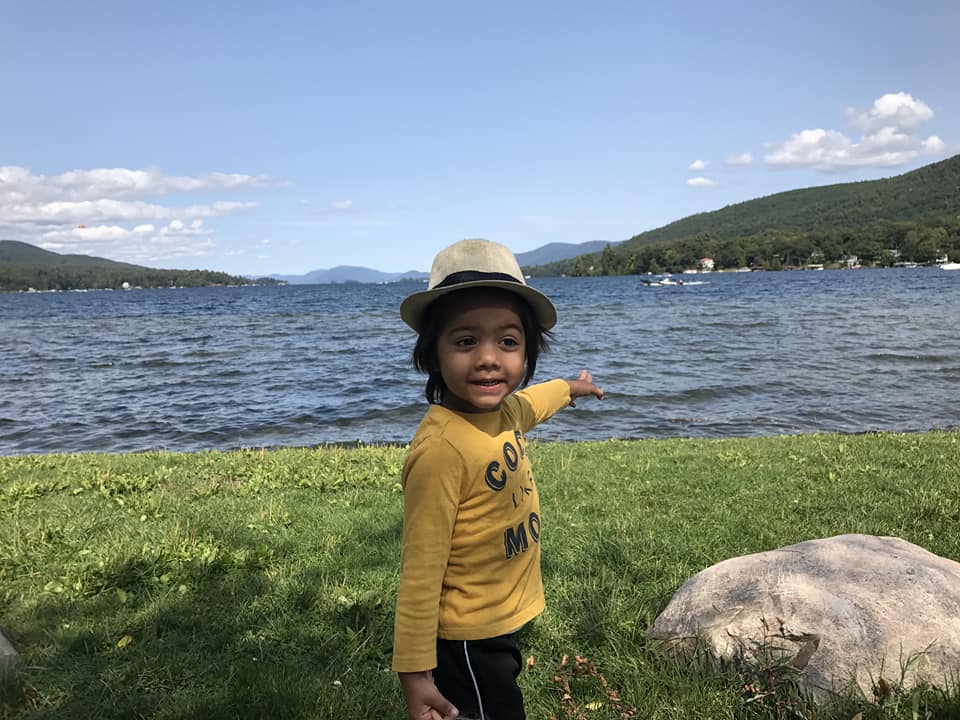 A young boy points to Lake George.