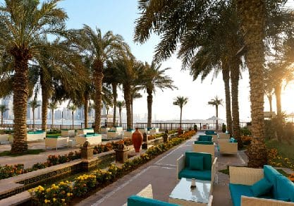A lovely area with outdoor seating at Fairmont The Palm, one of the best beachfront hotels in Dubai for families.