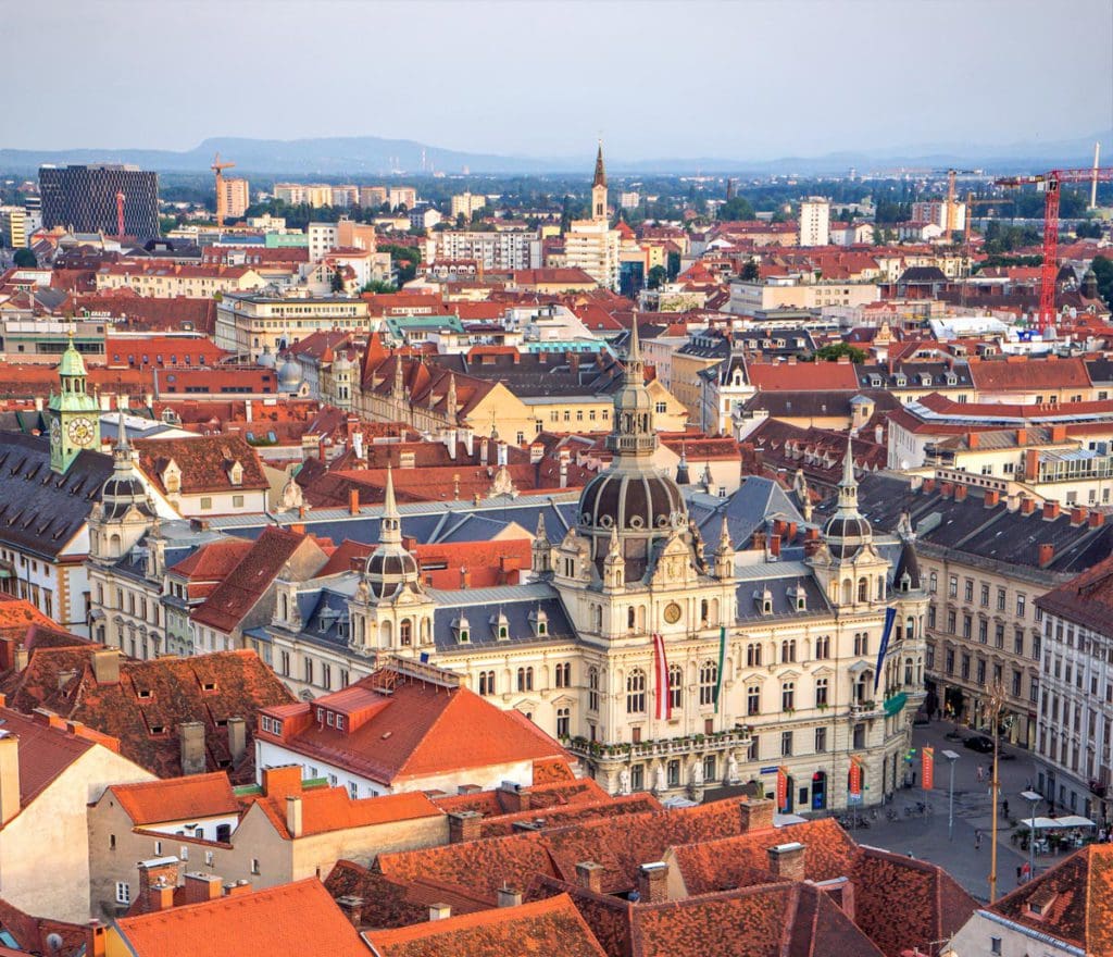 A lovely aerial view of the red rooftops of Graz, one of the best destinations in Austria with kids.