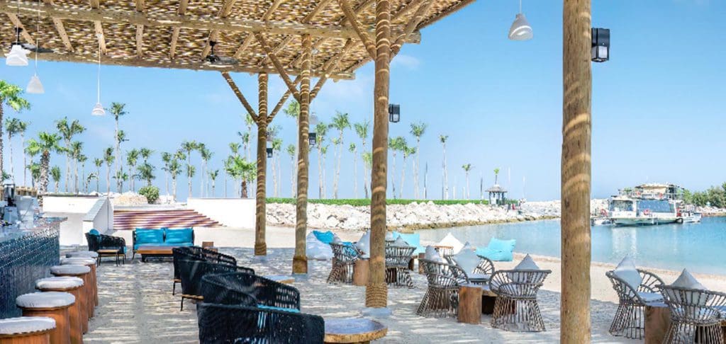 A lovely, covered beach area with ample seating at JA Beach Hotel, one of the best beachfront hotels in Dubai for families.