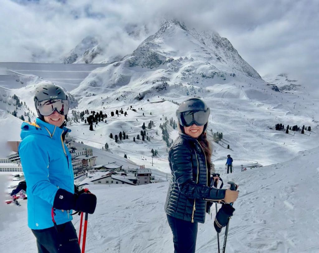 Two people on skis, enjoying a beautiful day on the slopes of Kühtai, Austria.