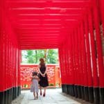 A mother and her daughter walk through Senbon Torii in Tokyo.