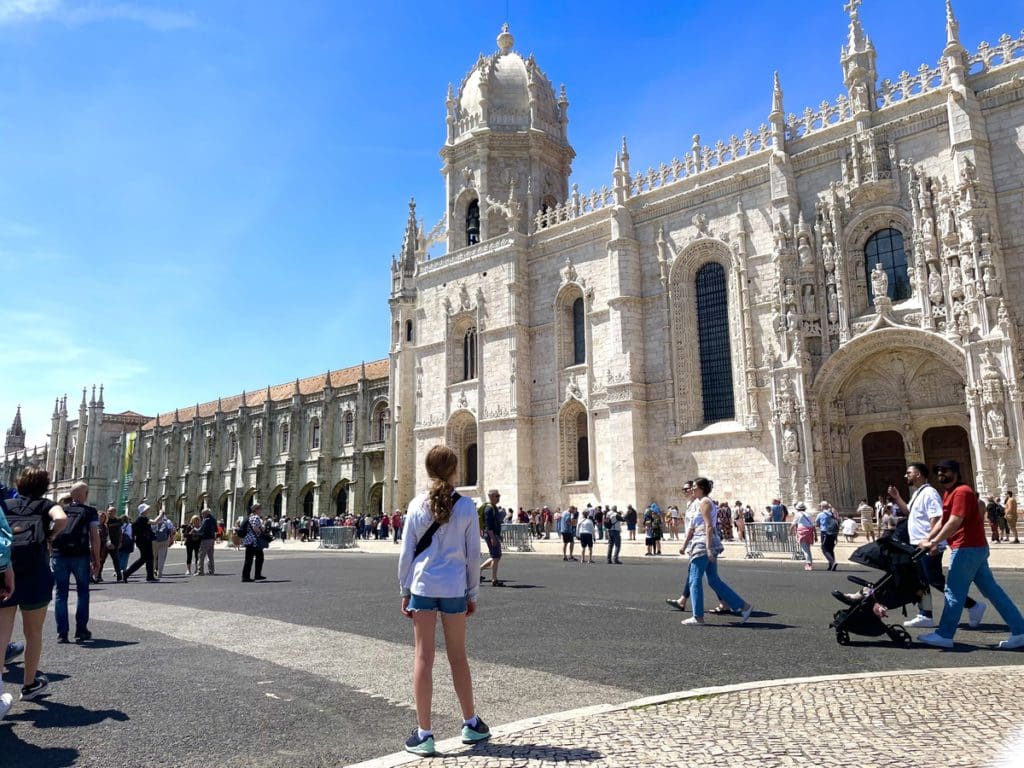A girl stands outside of the castle in Belem, a fun stop on any Lisbon itinerary with kids.