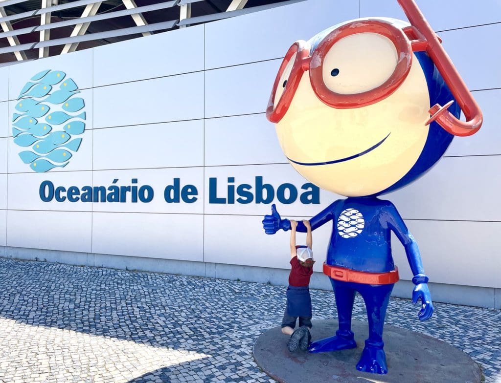 A young boy outside the Lisbon Aquarium. 