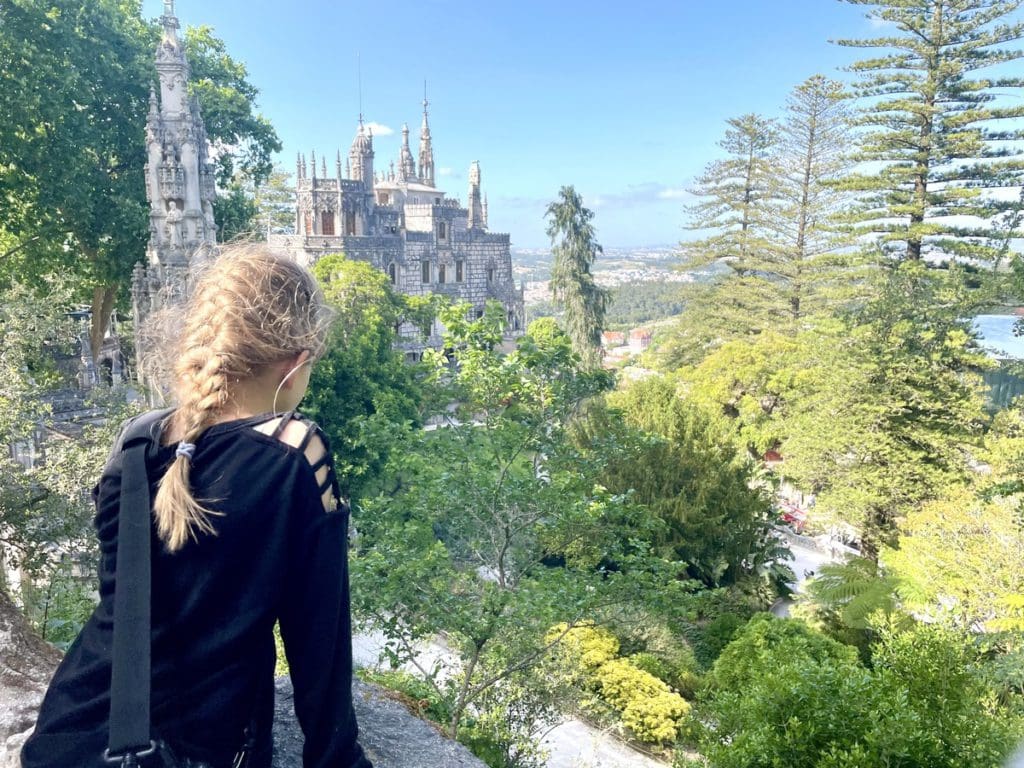 A young girl enjoys a sweeping view of Sintra, a fun stop on any Lisbon itinerary with kids.