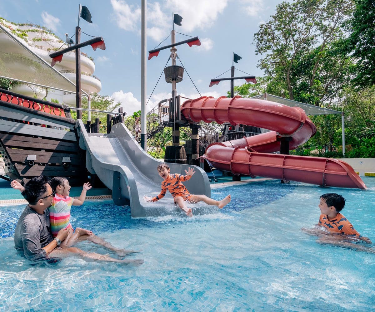 A family plays in the on-site water slide at Shangri-La Singapore.