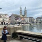 A young girl walks toward Lake Zurich, while exploring Zurich as a family.