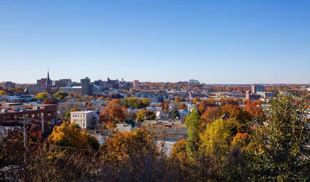 An aerial view of Portland, Maine, with vibrant fall foliage throughout the city.