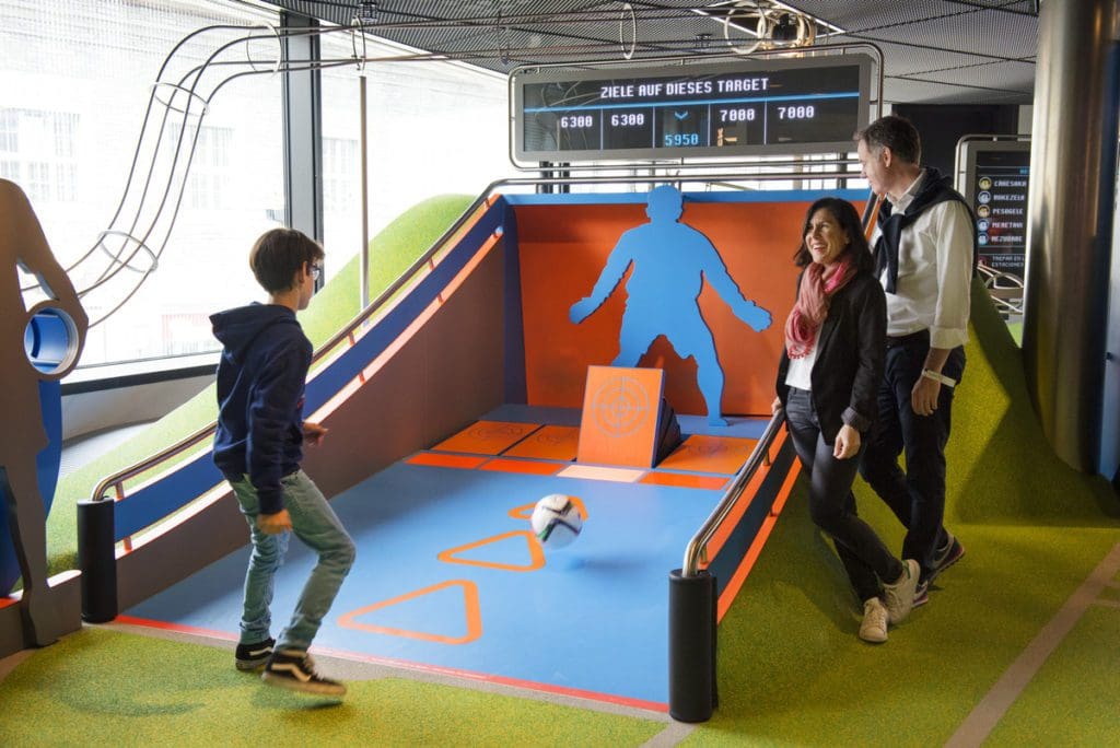 Kids play at an interactive exhibit at FIFA World Football Museum.