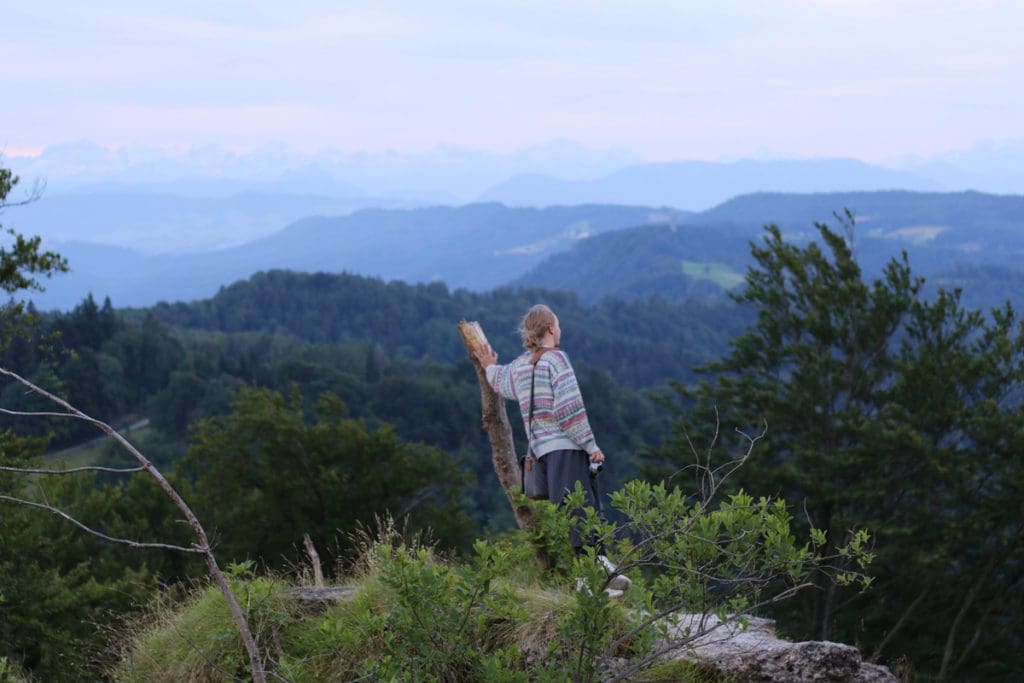 A woman enjoys a scenic view from Uetilberg Moutain.