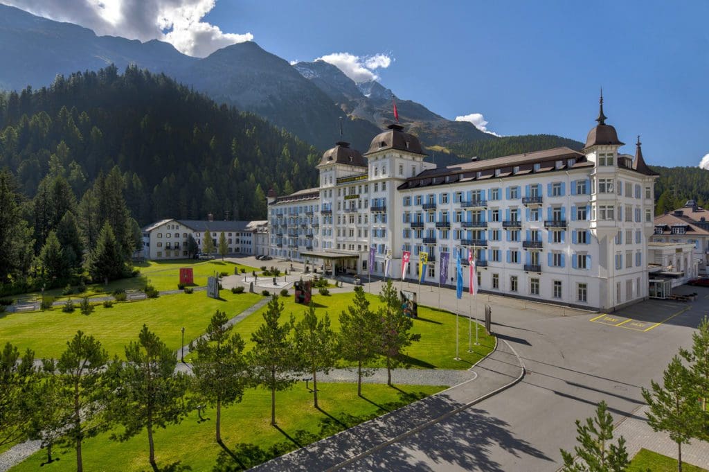 The exterior of Grand Hotel Des Bains Kempinski St. Moritz in the summer, one of the best hotels in St. Moritz for families.