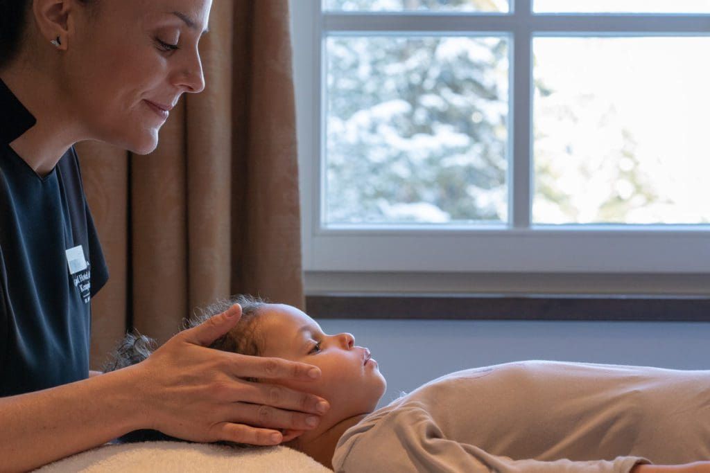 A young child receives a spa treatment at Grand Hotel Des Bains Kempinski St. Moritz.