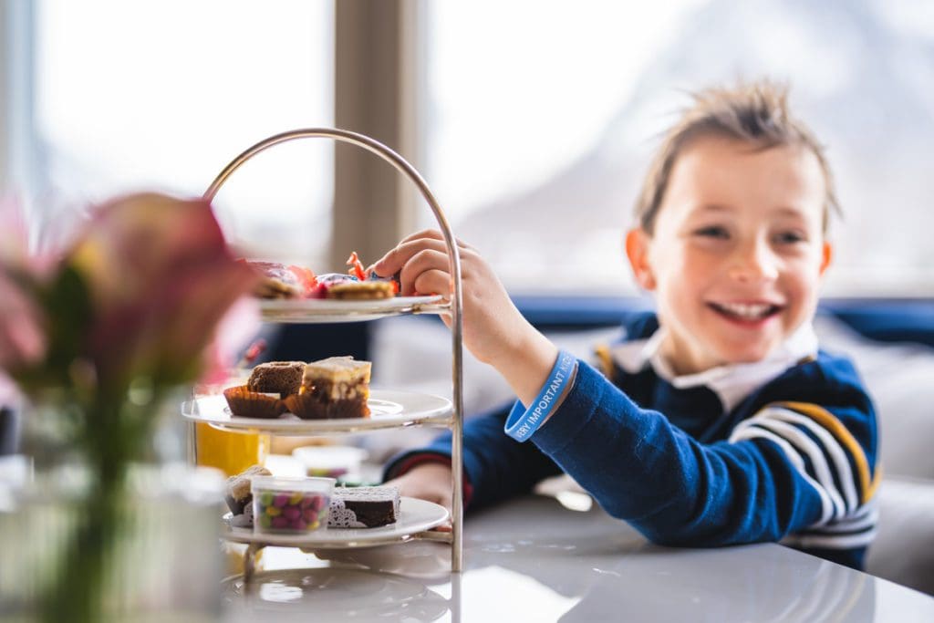 A young boy enjoys a treat in the dining area at Grand Hotel Kronenhof.