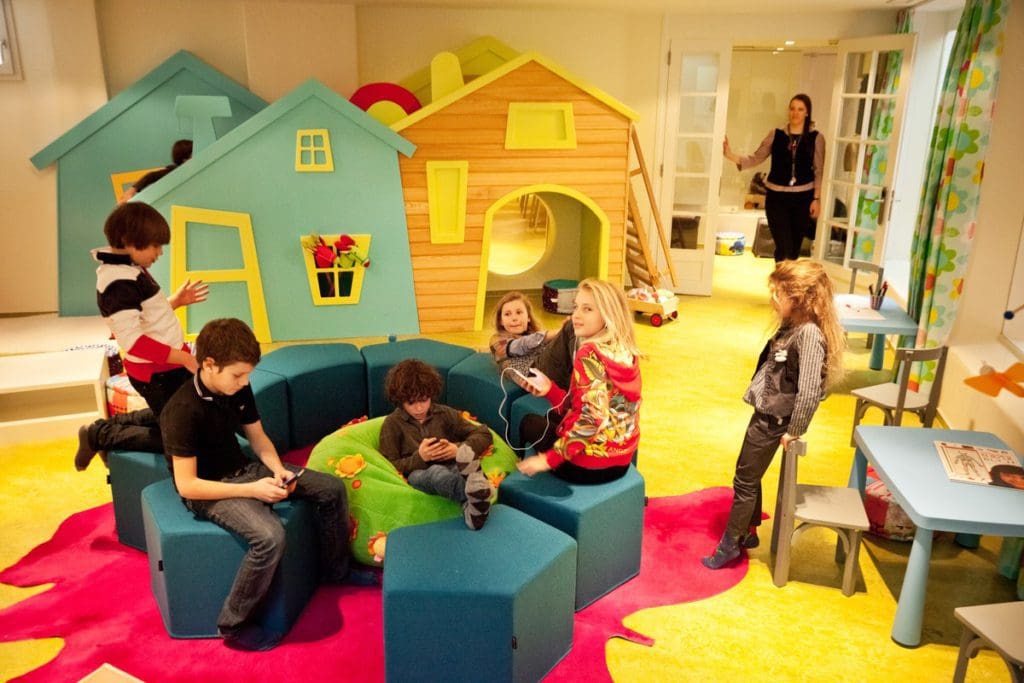 Several kids play in the colorful kids' club at Hotel Giardino Mountain.