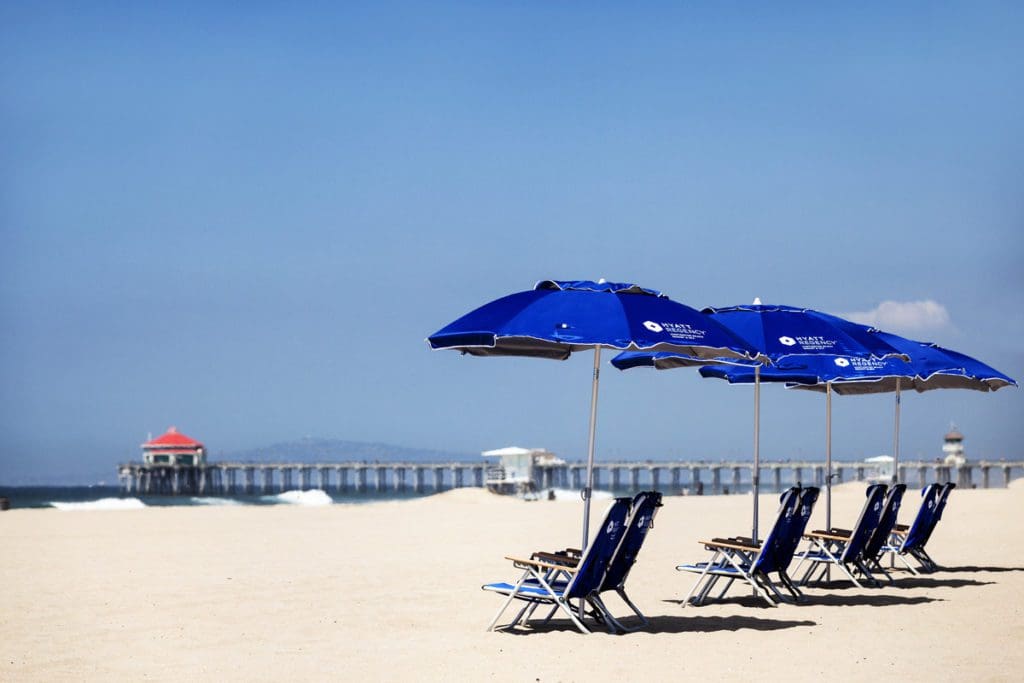 A series of beach loungers on an empty beach at Hyatt Regency Huntington Beach Resort.