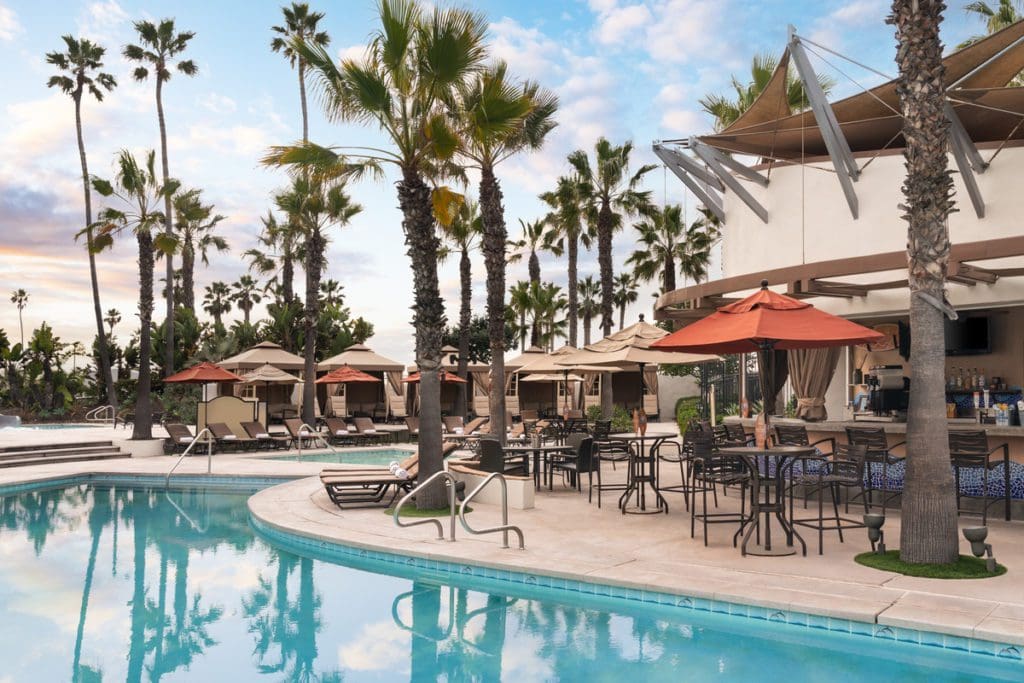 The outdoor pool, and surrounding pool deck, at Hyatt Regency Huntington Beach Resort.