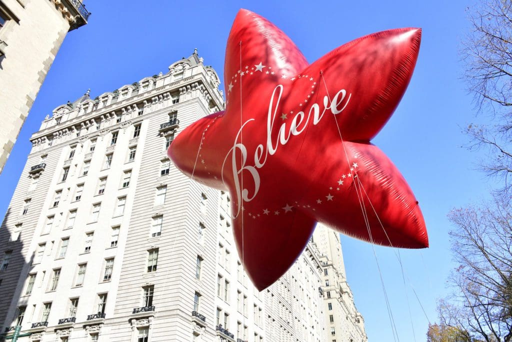 A star balloon reading "Believe" at the Macy's Day Parade.
